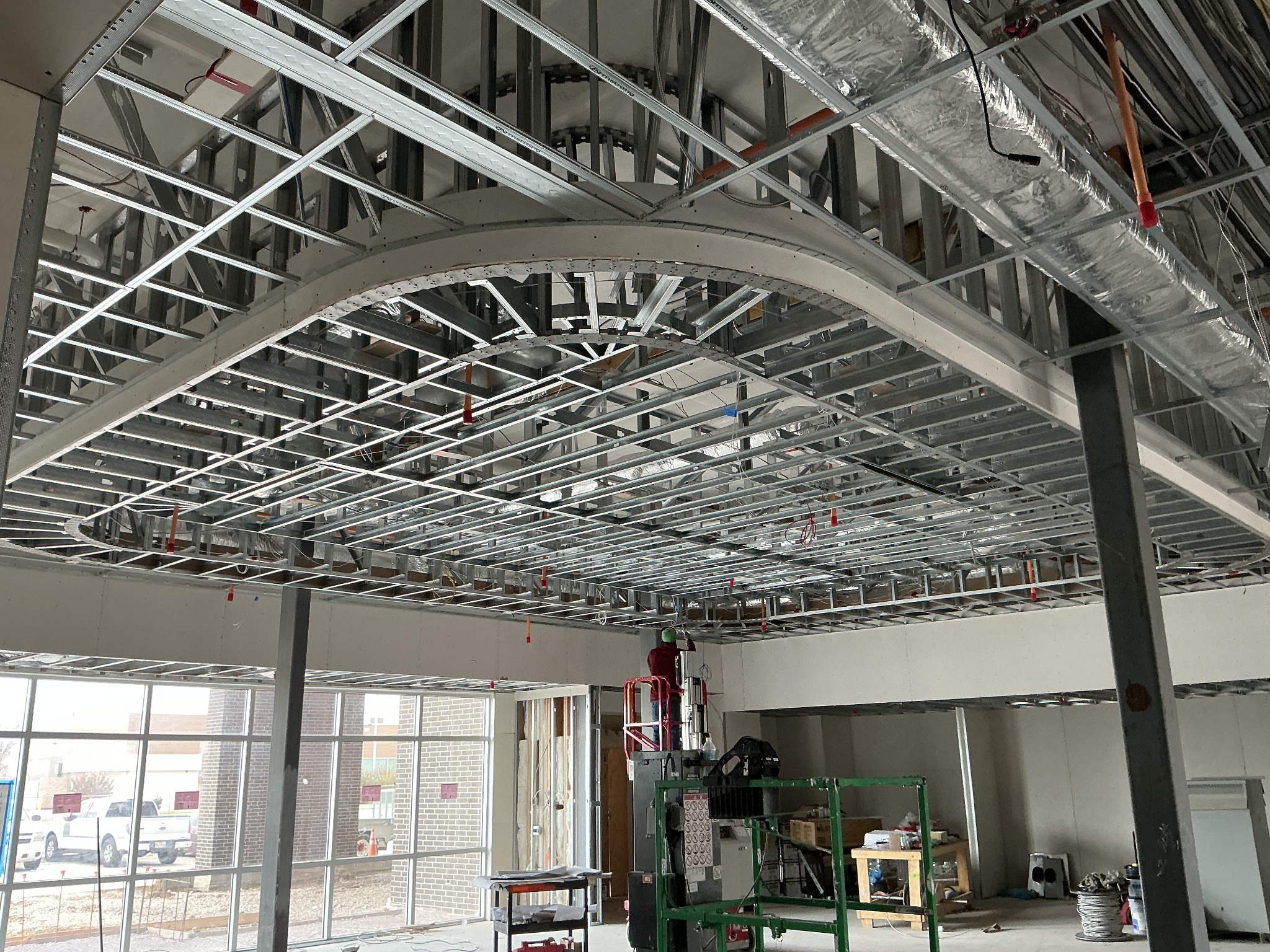 Interior metal framing with a curved ceiling detail under construction